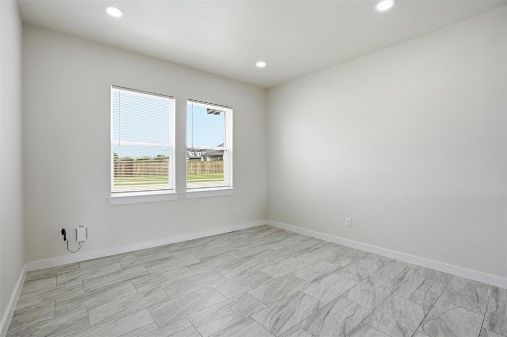 532 Highview Court Godley, TX 76044 - Photo 21 of 39 Room featuring two windows with blinds, recessed lighting, and light-toned tile flooring