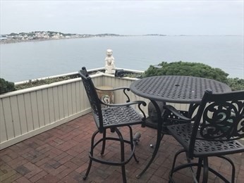 35 Oceanside Drive, Unit 35 Hull, MA 02045 - Photo 13 of 20 a view of a balcony with table and chairs