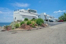 35 Oceanside Drive, Unit 35 Hull, MA 02045 - Photo 2 of 20 front view of a building with potted plants