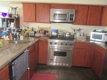 35 Oceanside Drive, Unit 35 Hull, MA 02045 - Photo 3 of 20 a kitchen with a stove and a microwave