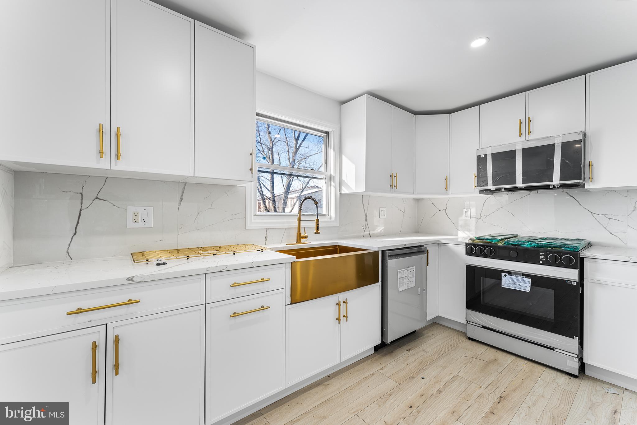 14 Rigel Court Sewell, NJ 08080 - Photo 12 of 40 a kitchen with stainless steel appliances granite countertop a stove a sink and a microwave