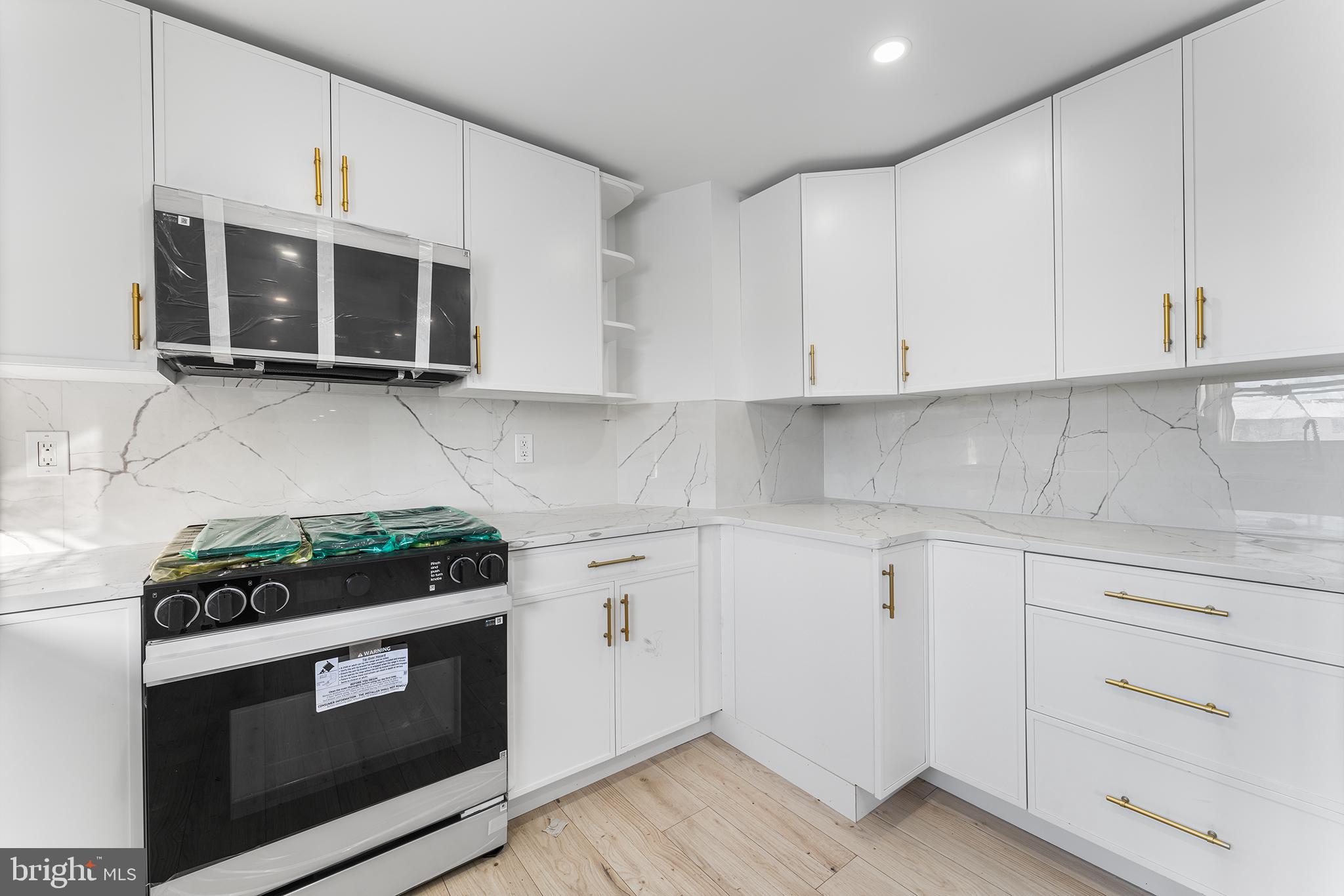 14 Rigel Court Sewell, NJ 08080 - Photo 13 of 40 a kitchen with stainless steel appliances granite countertop white cabinets and a stove a oven with white countertops