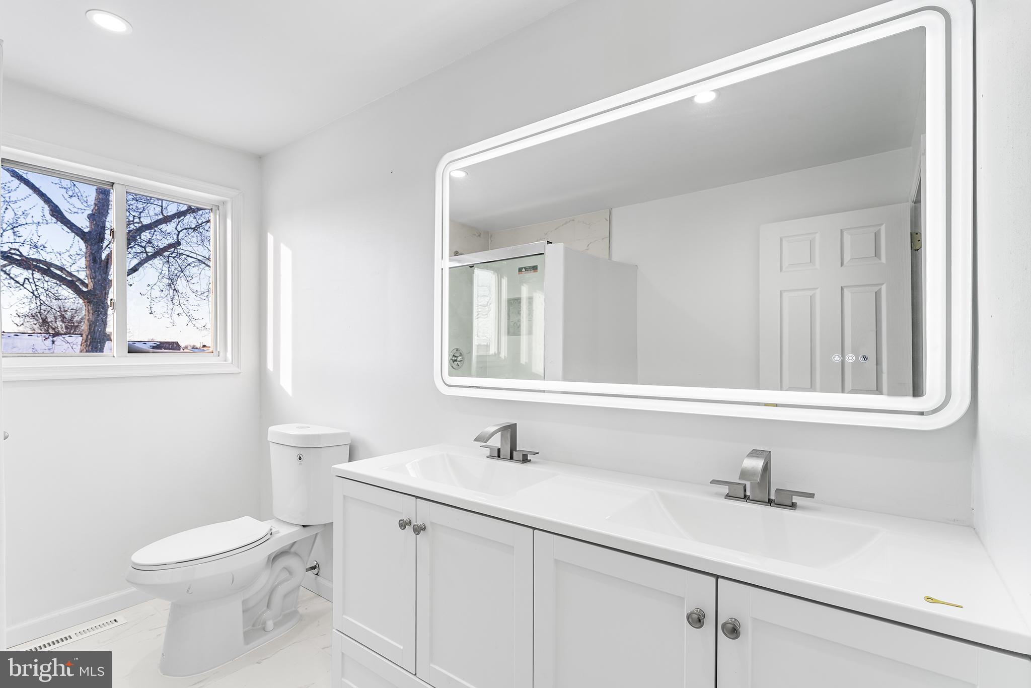 14 Rigel Court Sewell, NJ 08080 - Photo 25 of 40 a bathroom with a toilet a sink a mirror and a window