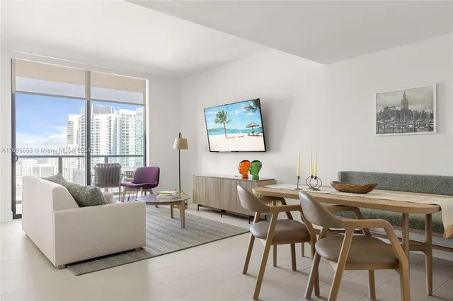 a work room with furniture and a large window