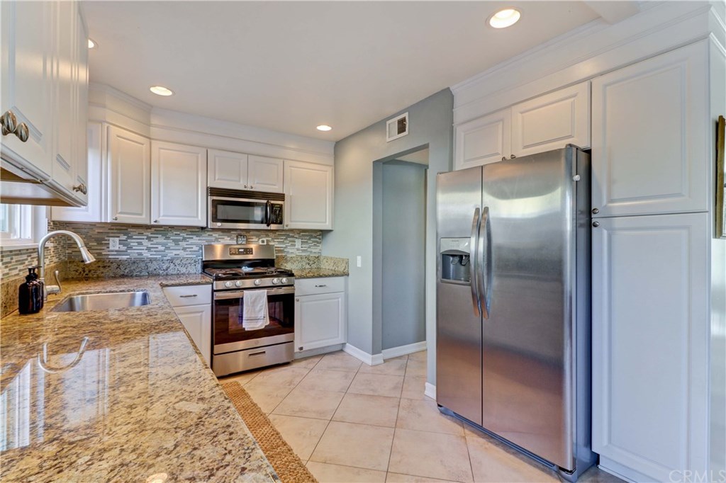 Beautifully updated oversized kitchen - a rare amount of kitchen space for a home of this size in Eastside Costa Mesa! Ready, set, cook!