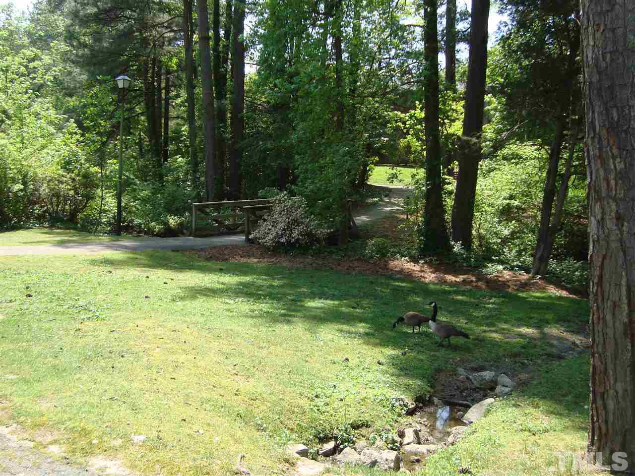 5104 Flint Ridge Place, Unit 5104 Raleigh, NC 27609 - Photo 3 of 12 a backyard of a house with a yard and outdoor seating