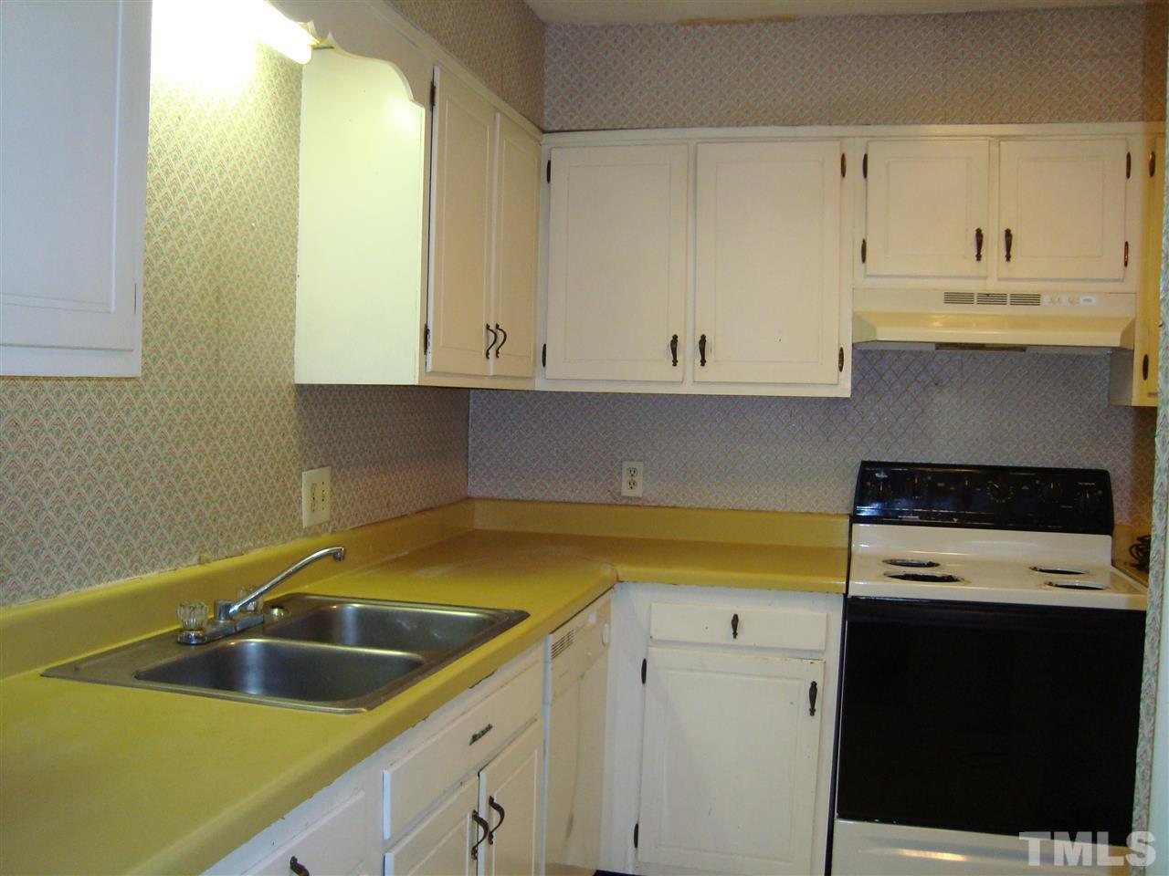 5104 Flint Ridge Place, Unit 5104 Raleigh, NC 27609 - Photo 5 of 12 a kitchen with a sink and cabinets