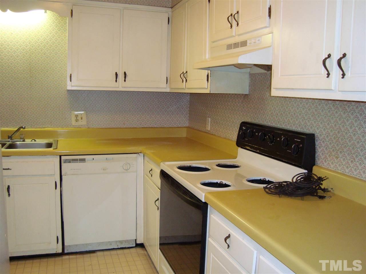 5104 Flint Ridge Place, Unit 5104 Raleigh, NC 27609 - Photo 6 of 12 a kitchen with a sink and cabinets