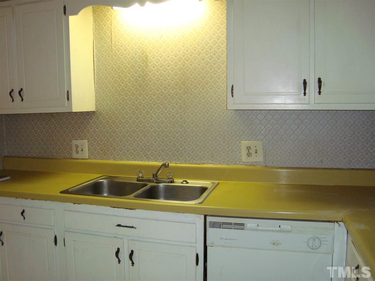 5104 Flint Ridge Place, Unit 5104 Raleigh, NC 27609 - Photo 10 of 12 a bathroom with a sink and cabinets