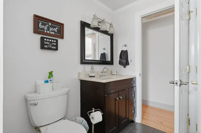 a bathroom with a toilet sink and mirror