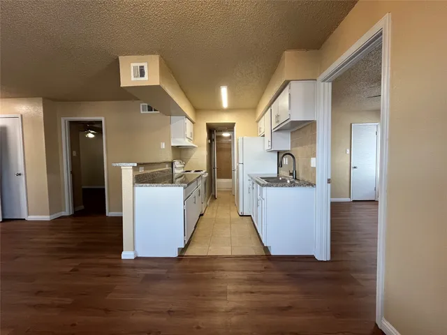 a view of kitchen with furniture and wooden floor