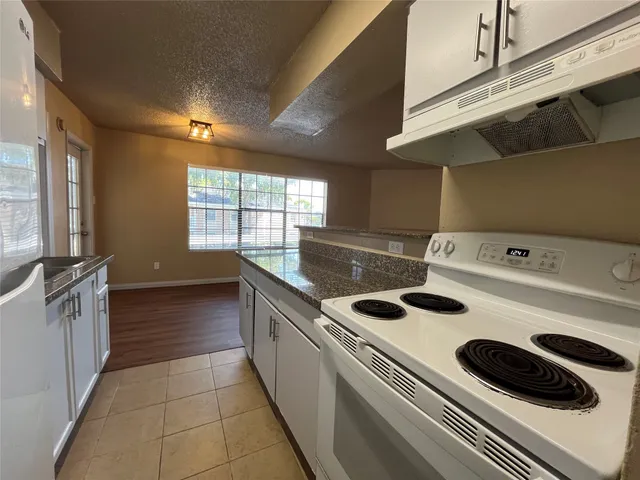 a kitchen that has a sink and a stove