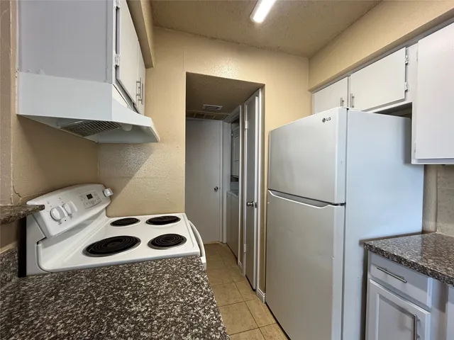 a refrigerator freezer sitting inside of a kitchen