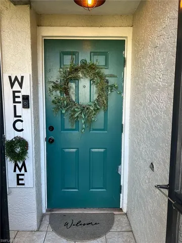 a view of a house with swimming pool and a table and chairs