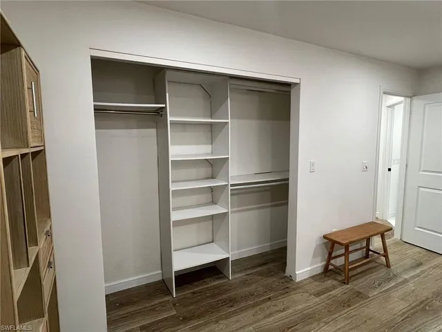 a view of walk in closet with empty racks