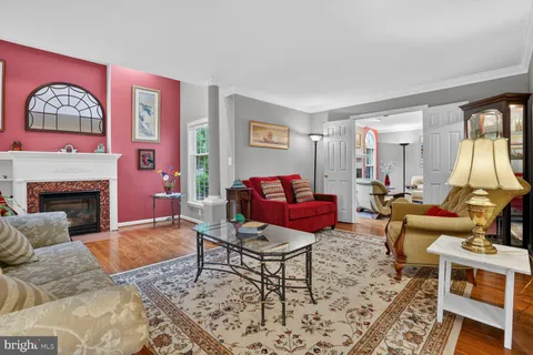 a living room with furniture a rug and a fireplace