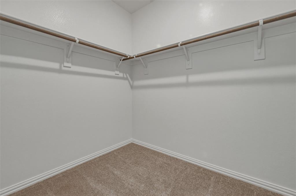 1201 Colca Drive Springtown, TX 76082 - Photo 20 of 32 Carpeted walk-in closet with white walls, white trim, and a built-in hanging rod system