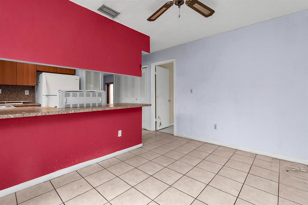 602 Southwest 99th Place Miami, FL 33174 - Photo 18 of 42 a kitchen with a sink a stove cabinets and utility