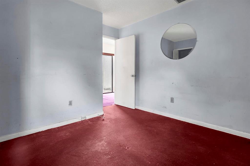 602 Southwest 99th Place Miami, FL 33174 - Photo 35 of 42 an empty room with wooden floor and windows