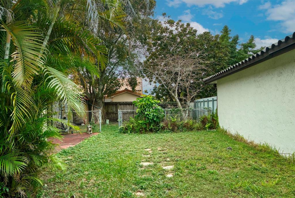 602 Southwest 99th Place Miami, FL 33174 - Photo 36 of 42 a yellow house with lots of trees