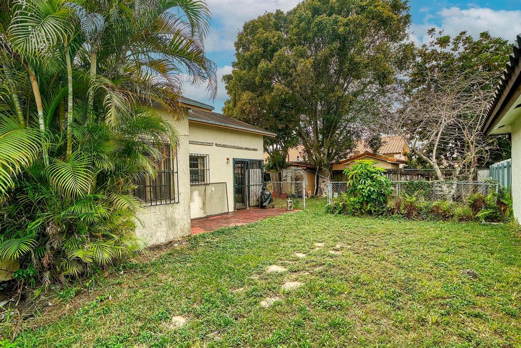 602 Southwest 99th Place Miami, FL 33174 - Photo 37 of 42 a front view of a house with a yard