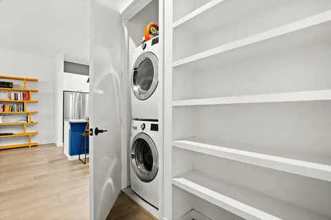 a view of front door with wooden floor and windows