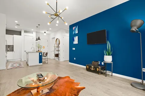 a view of a livingroom with furniture and a kitchen