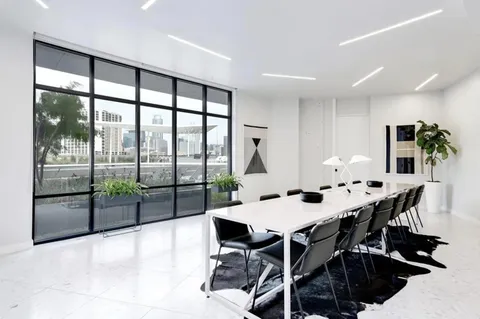 a kitchen with a table chairs and a kitchen