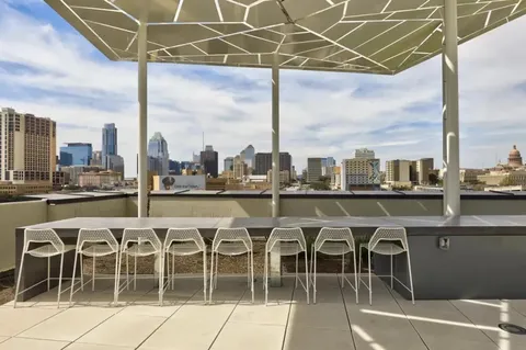 a living room with hardwood floor and a floor to ceiling window