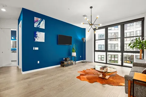 a living room with furniture a chandelier and a chandelier