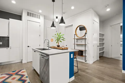 a kitchen with stainless steel appliances a refrigerator and a stove top oven