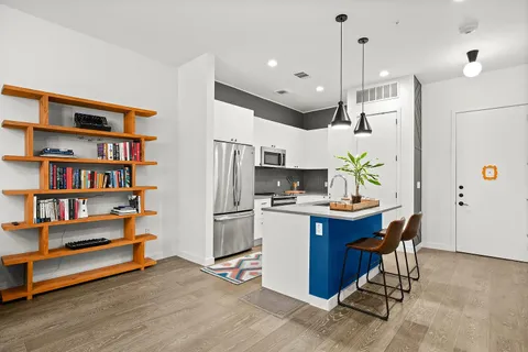 a bedroom with furniture and a book shelf