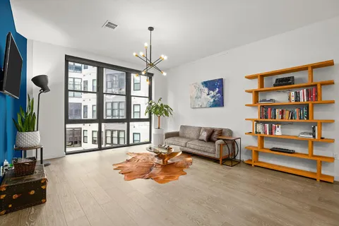 a living room with furniture and kitchen view