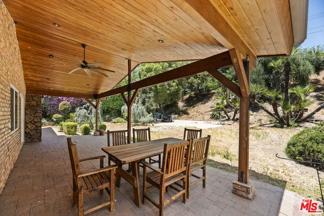 a view of a patio with a table chairs and a backyard