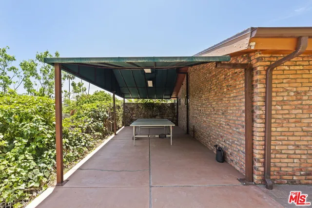 a backyard of a house with outdoor seating