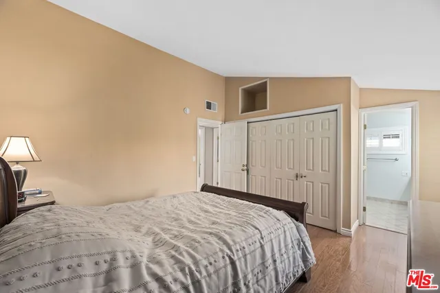 a bedroom with a bed and a mirror