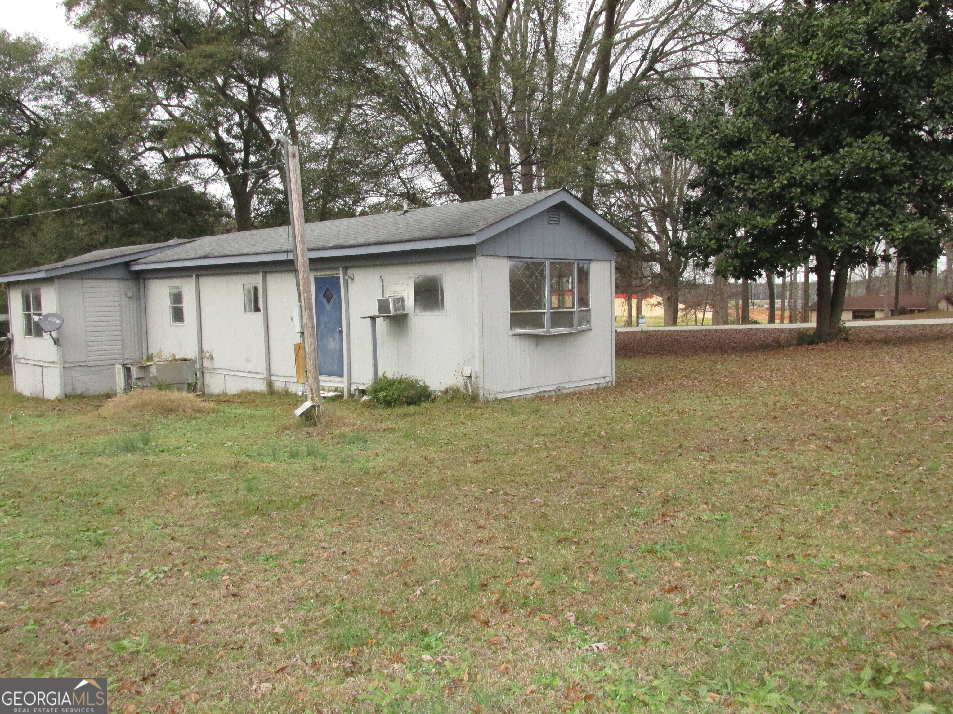 220 Carl Bethlehem Road Southwest Bethlehem, GA 30620 - Photo 10 of 11 a front view of house with yard and trees