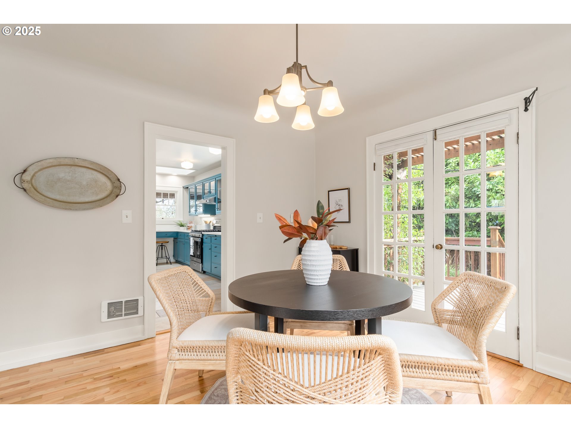 2033 East 19th Avenue Eugene, OR 97403 - Photo 12 of 45 a dining room with wooden floor a chandelier a glass table and chairs