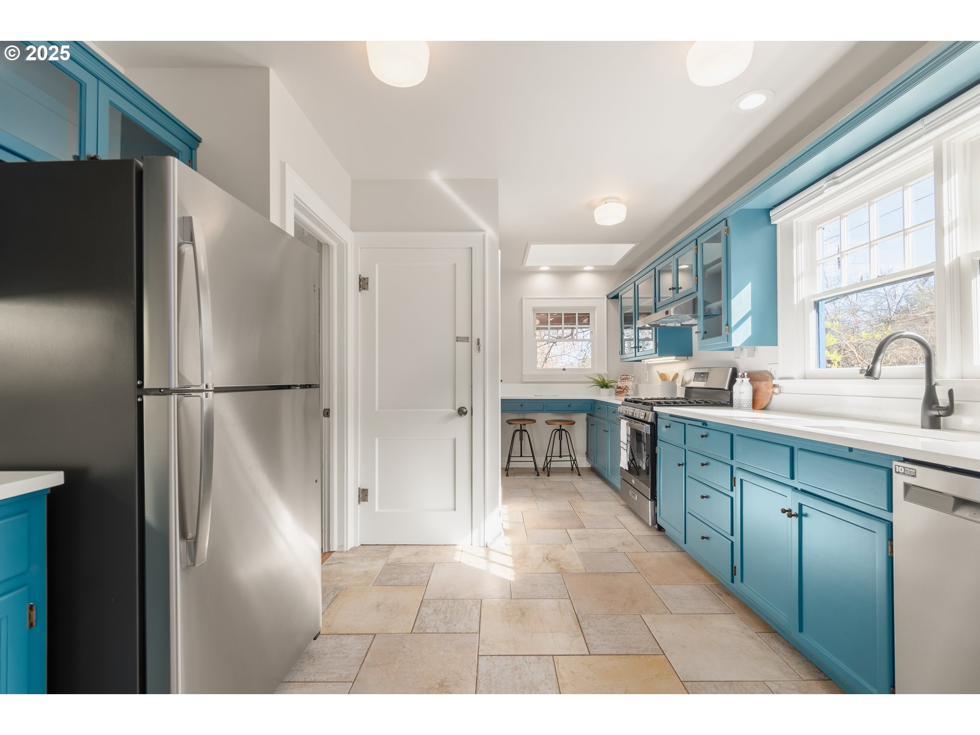 2033 East 19th Avenue Eugene, OR 97403 - Photo 13 of 45 a kitchen with stainless steel appliances granite countertop a refrigerator and a sink