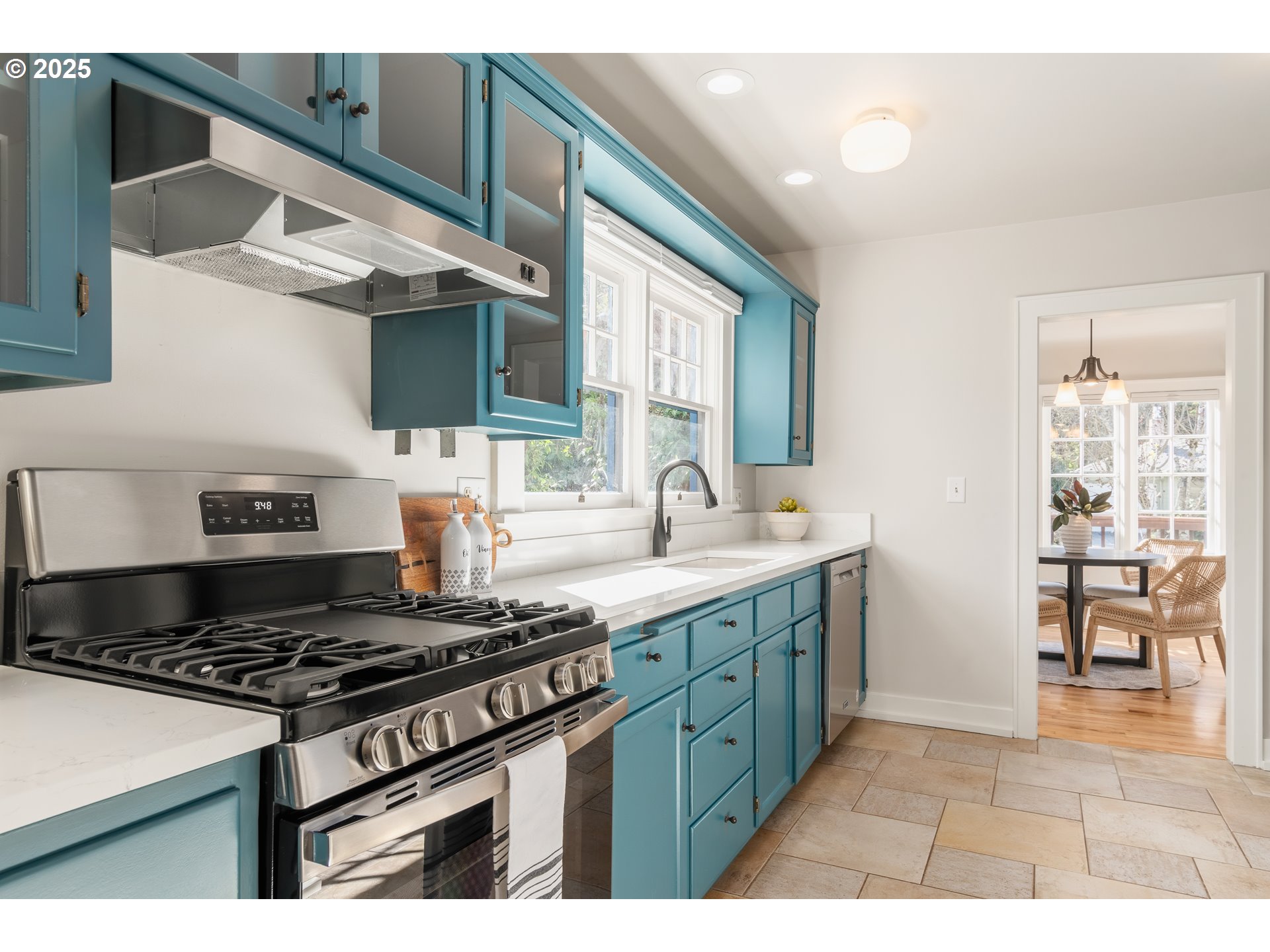 2033 East 19th Avenue Eugene, OR 97403 - Photo 15 of 45 a kitchen with stainless steel appliances granite countertop a stove and a sink