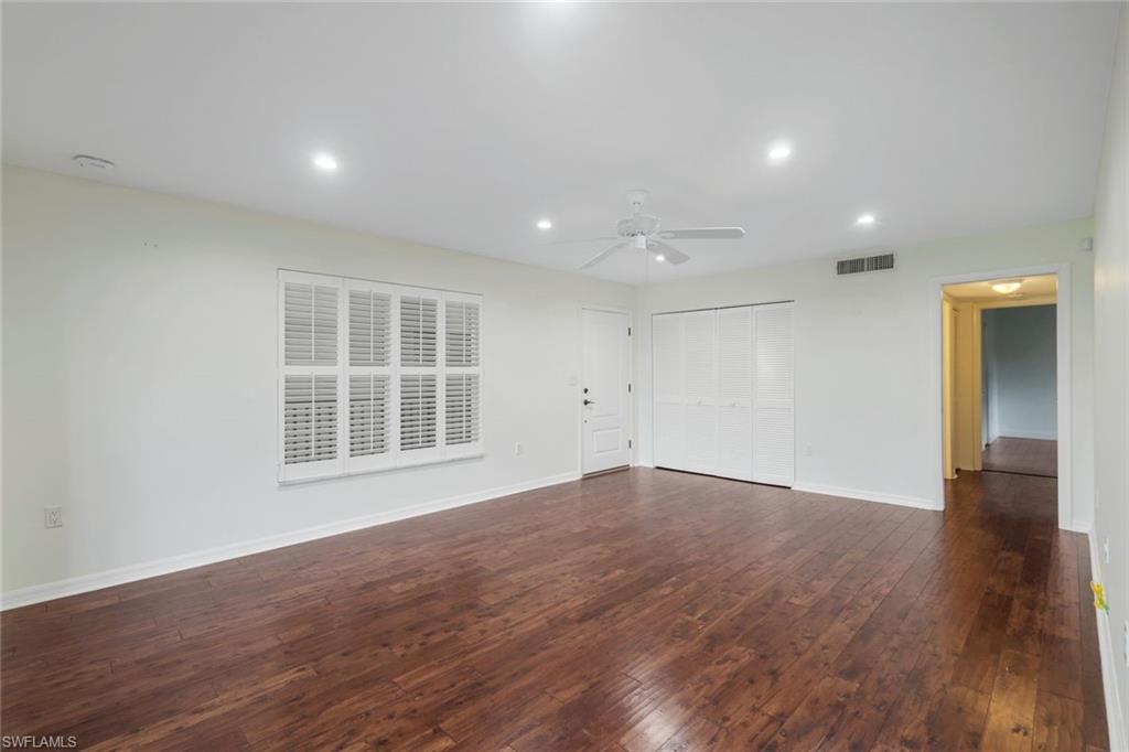 4160 Crayton Road, Unit A8 Naples, FL 34103 - Photo 11 of 26 a view of empty room with wooden floor and window
