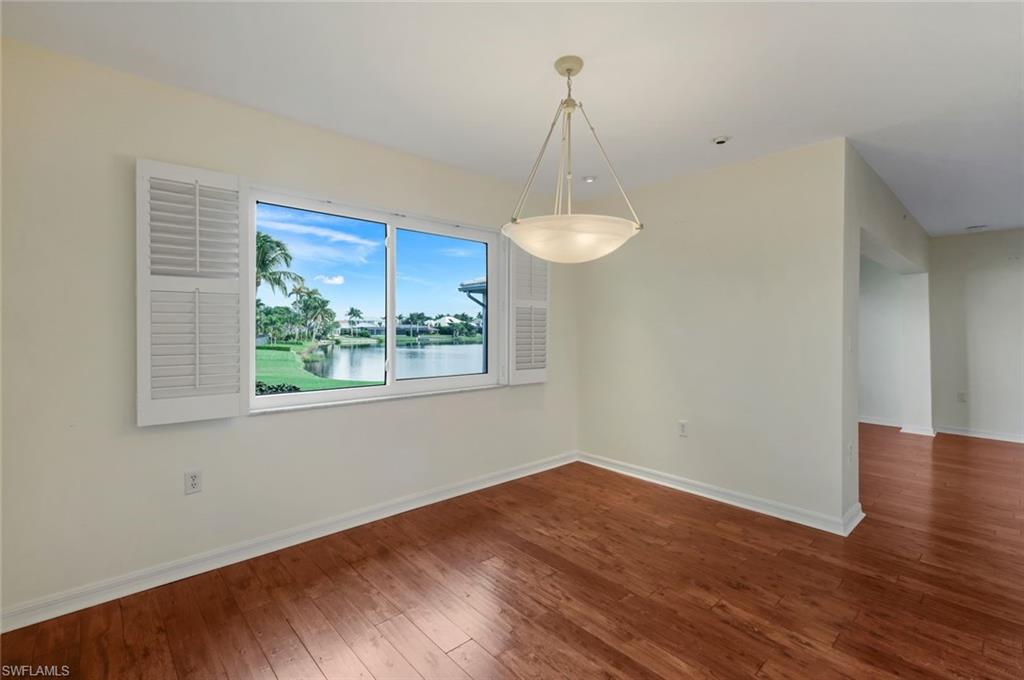 4160 Crayton Road, Unit A8 Naples, FL 34103 - Photo 13 of 26 a view of empty room with wooden floor and fan