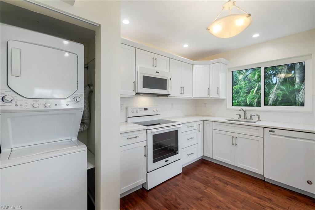 4160 Crayton Road, Unit A8 Naples, FL 34103 - Photo 15 of 26 a kitchen with a white stove top oven and sink