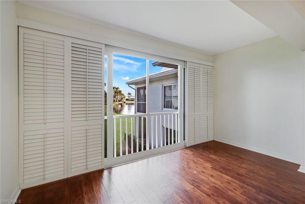 4160 Crayton Road, Unit A8 Naples, FL 34103 - Photo 24 of 26 a view of a livingroom with wooden floor and a window