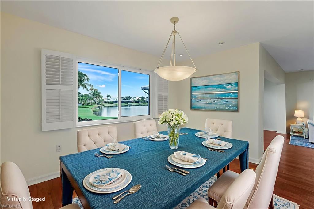 4160 Crayton Road, Unit A8 Naples, FL 34103 - Photo 4 of 26 a view of a dining room with furniture window and wooden floor