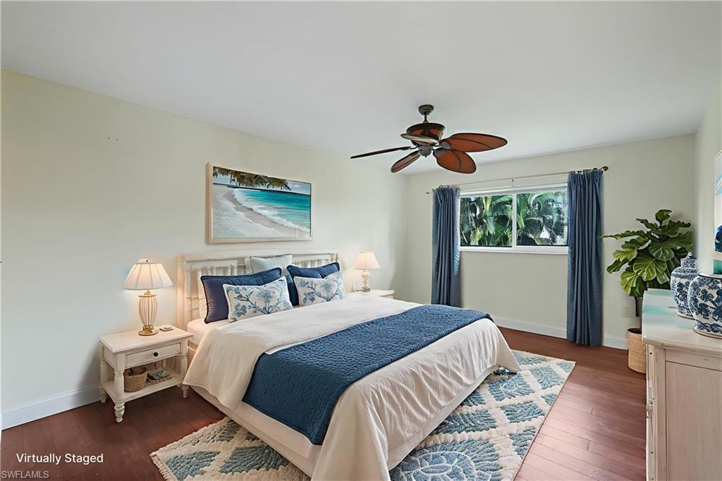 4160 Crayton Road, Unit A8 Naples, FL 34103 - Photo 6 of 26 a bedroom with a bed and a potted plant