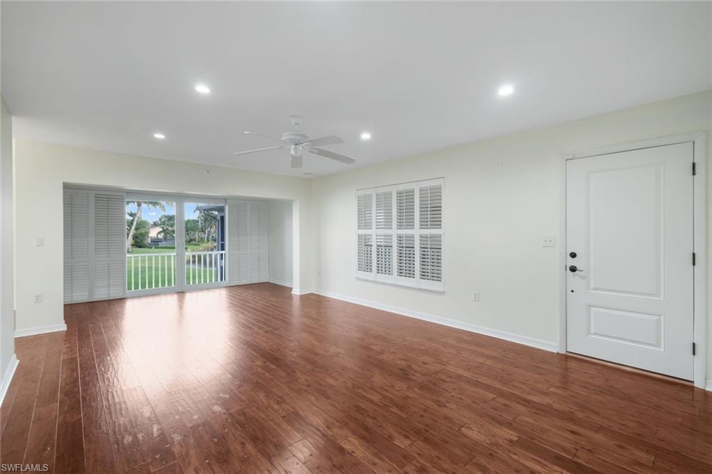 4160 Crayton Road, Unit A8 Naples, FL 34103 - Photo 8 of 26 a view of an empty room with wooden floor and a window