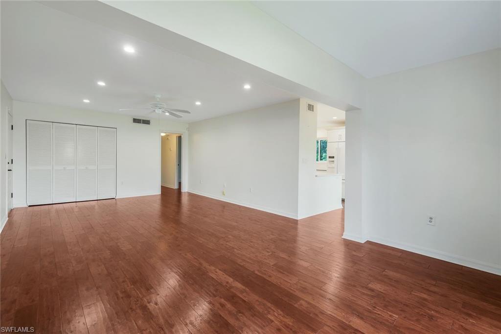 4160 Crayton Road, Unit A8 Naples, FL 34103 - Photo 9 of 26 a view of an empty room with wooden floor and closet