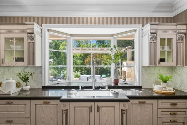 a utility room with granite countertop cabinets and washer