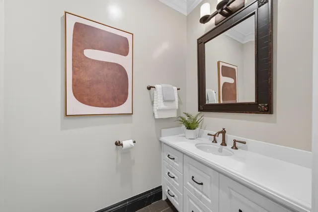 a spacious bedroom with a bed chandelier and window